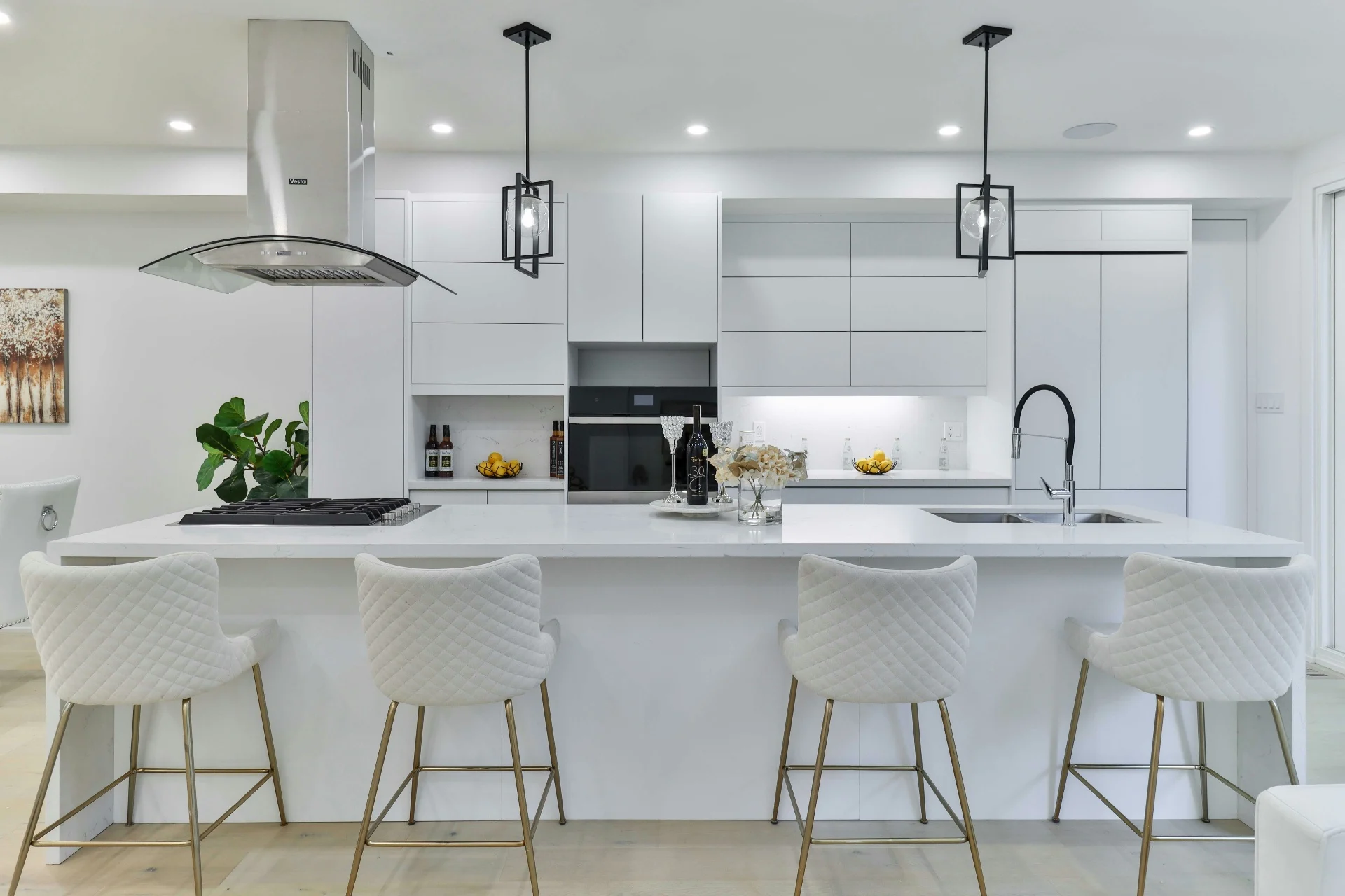 Modern white kitchen with quilted bar stools and pendant lighting